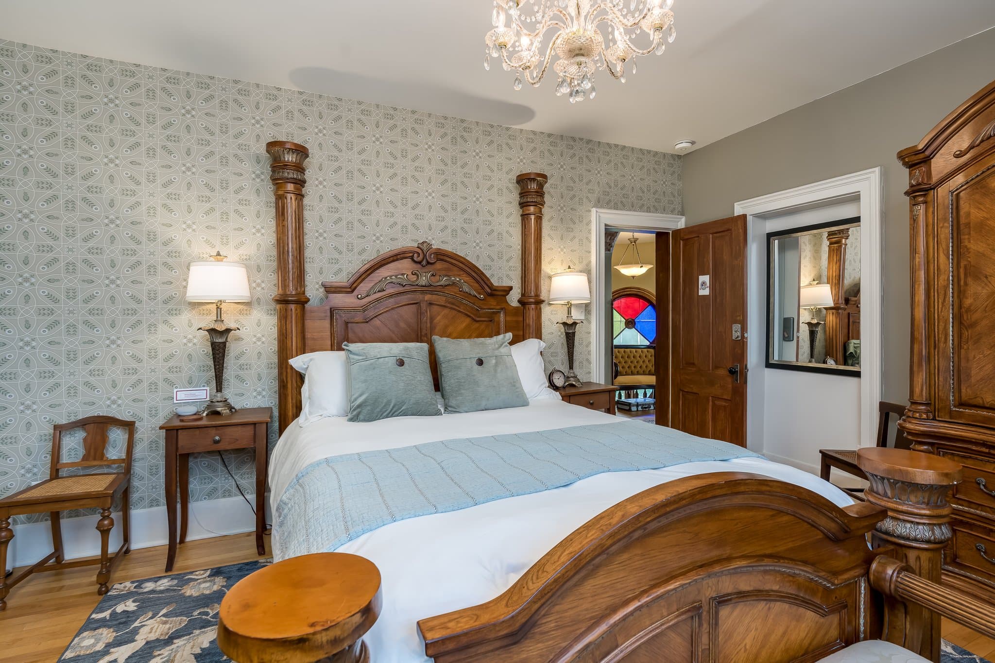 A cozy bedroom featuring a wooden bed, vintage decor, and soft lighting.